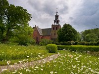 The church of  pieterburen  The church of the dutch village of pieterburen under a  dramatic sky : Netherlands, bloem, bloemen, boom, church, cloud, clouds, cloudy sky, creative nature, crow, crows, daisy, de marne, domies toen, dutch, flora, flower, garden, green, groen, groningen, holland, kerk, kerktoren, kraai, kraaien, landscape, landschap, leucanthemum vulgare, margriet, natural, natural gardening, nature garden, natuurlijk, natuurlijk tuinieren, natuurlijke, natuurtuin, nederland, pad, path, pieterburen, rudmer zwerver, scenery, sky, spring, steeple, summer, tree, tuin, wolk, wolken, wolkenlucht, zomer