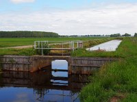 a weir in typical dutch agricultural landscape  a controlled weir in a canal : Polder, agrarische, agricultural, agriculture, barrage, beton, bloei, bloom, canal, channel, concrete, cows, creative nature, dam, ditch, drain, dutch, environmental, freshwater, gras, grass, groningen, holland, kanaal, laag, lageland, landbouw, landelijk, landscape, landschap, lente, low, management, milieu, natural, nature, natuur, natuurlijk, nederland, nederlands, niemand, nobody, reed, riet, rudmer zwerver, rural, slochteren, sloot, spring, springtime, structure, structuur, stuw, summer, vaart, water, waterfront, waterkant, waterkwaliteit, waterquality, waterschap, zoet water, zomer