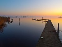 Bent jetty  Bent jetty during sunset over lake : Noordenveld, aanlegsteiger, afmeren, atmosphere, autumn, bent, bollard, calm, creative nature, dageraad, dawn, dusk, dutch, gebogen, geel, herfst, holland, hoogtezon, houten, jetty, kalm, lake, lakeside, landing stage, landscape, landschap, leek, leekstermeer, lente, licht, light, lucht, matsloot, meer, mist, mooring, natural, nature, natuur, natuurlijk, nederland, nederlands, orange, oranje, paal, peace, pier, post, quiet, reflect, reflecteren, reflectie, reflection, rudmer zwerver, rustig, sandebuur, schemering, sereen, serene, sfeer, sky, spectaculaire, spectacular, spring, steiger, summer, sun, sunbeam, sunlight, sunray, sunrise, sunset, sunshine, tranquil, twilight, vredig, water, windstil, wooden, yellow, zomer, zon, zonlicht, zonneschijn, zonnestraal, zonsondergang, zonsopgang