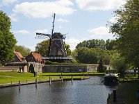 Wooden cornmill "De Kaai" on defences of Dutch city Sloten, Friesland  Wooden cornmill "De Kaai" on defences of Dutch city Sloten, Friesland : sleat, sloten, friesland, de friese meren, Europe, european, fryslan, Holland, Netherlands, architecture, blue sky, clouds, cornmill, historic, history, landmark, mill, monument, monumental, old, outdoors, outside, sails, sky, thatched roof, the past, windmill, wood, wooden, defences, wall, canal, water