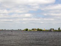 Typical landscape with lakes of Dutch province Friesland  Typical landscape with lakes of Dutch province Friesland : sky, skyscape, cloud, clouds, cloudscape, outside, outdoor, landscape, rural landscape, countryside, rural scene, non-urban scene, lake, water, land, Friesland, Frylan, Dutch, Holland, Netherlands, Europe, European, no people, nobody, summer, summertime, spring, springtime, room, recreation, reed, relaxation, ship, water sports, aquatic sport, boat, horizon, horizon over water