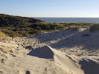 Sand dune partly covered with grass and bushes; Zeeland, Netherlands  Sand dune partly covered with grass and bushes; Zeeland, Netherlands : Ammophila arenaria, autumn, Burgh-Haamstede, bush, bushes, dune, dunes, dutch, europe, european, fall, grass, growth, landscape, marram grass, natural, nature, Netherlands, no people, nobody, non-urban scene, North Sea, rural, rural landscape, rural scene, sand, sandy, sea, summer, summertime, water, Zeeland