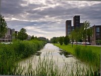 Dutch residential area  Canal in a dutch suburban residential area : Netherlands, alg, algae, algen, architecture, building, canal, city, clouds, construction, contemporary, creative nature, dark clouds, ditch, donkere wolken, dutch, flat, grass, green, holland, home, house, houses, housing, housing market, huis, huizen, huizenmarkt, landscape, landschap, lucht, modern, nederland, overcrowding, overpopulation, population, reed, residential, residential area, riet, rijtjeshuis, row house, rudmer zwerver, scenery, sky, sloot, suburban, summer, the hague, toren, tower, urban, vinex, water, water district, wijk, wolken, wonen, woningmarkt, woonwijk, ypenburg