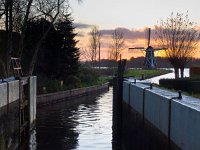 Dutch lock chamber  Dutch lock chamber with vintage windmill backdrop during sunset : Netherlands, aanleggen, aanmeren, atmosphere, boating, channel, dawn, dusk, groningen, holland, kanaal, knotwilg, landscape, landschap, lock, lock door, mill, molen, moor, mooring, nederland, orange, oranje, paterswolde, paterswoldsemeer, pleziervaart, rudmer zwerver, sailing, sfeer, sluis, sluisdeur, sunrise, sunset, vaart, water, water sports, watersport, willow, zonsondergang