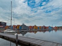 A sailing boat  A sailing boat in front of a residential area : Netherlands, architecture, architectuur, blauw, blue, boat, boats, bollard, boot, boten, building, buildings, colorful, colors, dorkwerd, gebouw, gebouwen, geel, gray, grijs, groningen, harbour, haven, holland, home, house, houses, housing, huis, huisvesting, huizen, jachthaven, jetty, kleuren, kleurrijk, landscape, marina, nederland, orange, oranje, paal, reitdiep, reitdiephaven, residential, rudmer zwerver, schepen, schip, ship, steiger, suburb, thuis, vinex, voorstad, water district, waterfront living, waterwijk, wonen aan het water wonen, woningen, yellow, zeilboot, zeilschip