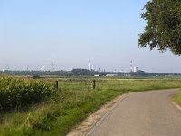 NL, Noord-Brabant, Woensdrecht 3, Saxifraga-Roel Meijer  Country road with industries of Antwerp, Belgium in background : Antwerp, asphalt, Belgium, corn, country lane, country road, countryside, grassland, industry, Maize, pasture, rural landscape, tree, wind tubinegrass