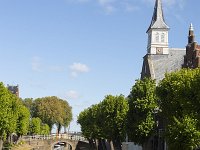 Canal in historic Dutch  town Sloten, Friesland  Canal in historic Dutch  town Sloten, Friesland : sleat, sloten, friesland, de friese meren, Europe, european, fryslan, Holland, Netherlands, blue, canal, coud, espalier, frisian, green, historic, history, in a row, many, road, row, sky, street, the way to go, town, tree, trees, urban landscape, urban scene, water, white clouds, church, tower, bridge