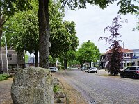 Mainstreet of Dutch village Sellingen, Groningen, Netherlands  Mainstreet of Dutch village Sellingen, Groningen, Netherlands : mainstreet, village, glacial erratic, glacial erratics, stone, stones, boulder, boulders, road, tree, trees, car, cars, asphalt, street bricks, sellingen, westerwolde, groningen, netherlands, holland, dutch, europe, european