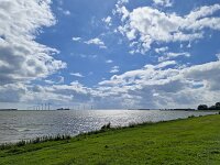 View of Lake IJssel off the coast near  Dutch village Lemmer, Friesland  View of Lake IJssel off the coast near  Dutch village Lemmer, Friesland : lake IJssel, IJsselmeer, coast, sky, cloud, clouds, cloudy, sky scape, nature, natural, rural, landscape, rural landscape, rural scene, non-urban landscape, non-urban scene, outside, outdoor, outdoors, no people, nobody, summer, summertime, spring, springtime, europe, european, netherlands, holland, dutch, Friesland, Fryslan, Lemmer, dike, grass, grassland, green bank