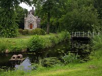 Garden of monumental building Coopersburg with mausoleum, Akkrum, Friesland, Netherlands  Garden of monumental building Coopersburg with mausoleum, Akkrum, Friesland, Netherlands : mausoleum Coopersburg, mausoleum, coopersburg, building, architecture, monument, monumental, historic, history, culture, dutch culture, gable, door, front door, art nouveau, 1906, Johan Schroder, no people, nobody, outside, europe, european, garden, bridge, pond, water, tree, pasture, Akkrum, Friesland, Netherlands