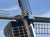 Cross of sails of historic windmill Doris Mooltsje, Oudega, Sudwest-Fryslan, Friesland, Netherlands  Cross of sails of historic windmill Doris Mooltsje, Oudega, Sudwest-Fryslan, Friesland, Netherlands : windmill, Doris Mooltsje, Oudega, Aldegea, Sudwest-Fryslan, Friesland, Netherlands, Dutch, europe, european, building, architecture, monument, historic, history, culture, dutch culture, travel destination, destination, black, 4, four, rural, landscape, rural landscape, outside, outdoor, outdoors, no people, nobody, season, summer, summertime, sky, blue sky, white clouds, sailss, cross