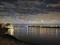 Light show over Dutch river Noord, South Holland, Netherlands  Light show over Dutch river Noord, South Holland, Netherlands : light show, light, show, evening, night, dark, light ray, rays, river, stream, waterway, Noord, South Holland, Netherlands, Dutch, Holland, dark sky, sky, water, river bank, landscape, riverscape, outside, outdoor, outdoors, nobody, no people, europe, european, cloud, clouds, cloudy