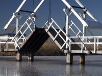 NL, Zuid-Holland, Molenwaard, Kinderdijk 6, Saxifraga-Roel Meijer  Opened wooden draw bridge, Unesco World Heritage Site Kinderdijk, South Holland, Netherlands : icy, winter, wintertime, blue sky, reed, reflection, reflected, unesco world heritage site, Kinderdijk, South Holland, Holland, Netherlands, wooden, bridge, draw bridge, open, travel destinations. canal, ice