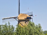 Windmill of World Heritage Site Kinderdijk under a blue sky  Windmill of World Heritage Site Kinderdijk under a blue sky : windmill, Holland, Netherlands, South Holland, Kinderdijk, Alblasserwaard, landmark, historic, building, monument, countryside, rural landscape, travel destinations, travel locations, tourism, Unesco, World Heritage Site, heritage, the past, history, reed, canal, water, rural, rural scene, scenic, non-urban scene, blue sky, clear sky, outside, outdoor, outdoors, no people, nobody, summer, summertime, tree, trees, mill, sail, sails