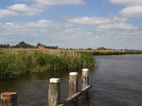 Typical landscape with lakes of Dutch province Friesland  Typical landscape with lakes of Dutch province Friesland : sky, skyscape, cloud, clouds, cloudscape, outside, outdoor, landscape, rural landscape, countryside, rural scene, non-urban scene, lake, water, land, Friesland, Frylan, Dutch, Holland, Netherlands, Europe, European, no people, nobody, summer, summertime, spring, springtime, room, recreation, reed, relaxation, farm, farmland, mooring poles, row, in a row, horizon, horizon over land, pole, poles