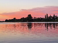 View on Dutch water sports village during sunset, Oudega, Friesland, Netherlands  View on Dutch water sports village during sunset, Oudega, Friesland, Netherlands : view, water sports, village, Oudega, Aldegea, Sudwest-Fryslan, friesland, fryslan, netherlands, holland, dutch, europe, european, aquatic sports, lake, water, city scape, landscape, outside, outdoor, outdoors, no people, nobody, season, summer, summertime, house, houses, building, aldegeaster brekken, sunset, evening, sun, sky, red, romantic, twilight, dusk, grow dark
