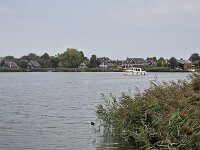 View on Dutch water sports village Oudega, Friesland, Netherlands  View on Dutch water sports village Oudega, Friesland, Netherlands : view, water sports, village, Oudega, Aldegea, Sudwest-Fryslan, friesland, fryslan, netherlands, holland, dutch, europe, european, boat, ship, aquatic sports, lake, water, city scape, landscape, outside, outdoor, outdoors, no people, nobody, season, summer, summertime, house, houses, building, aldegeaster brekken, yacht